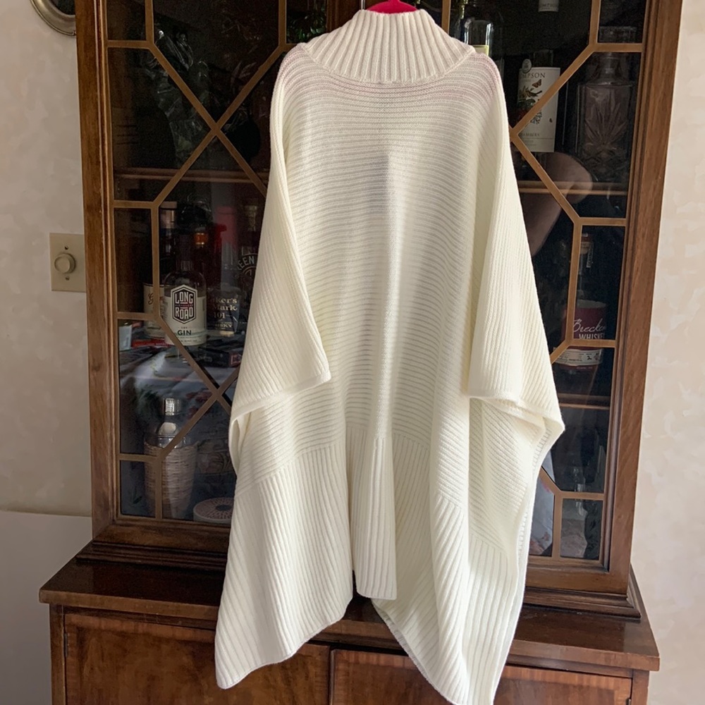 Soft white, high neck poncho. Full silver zipper in front. Very soft.